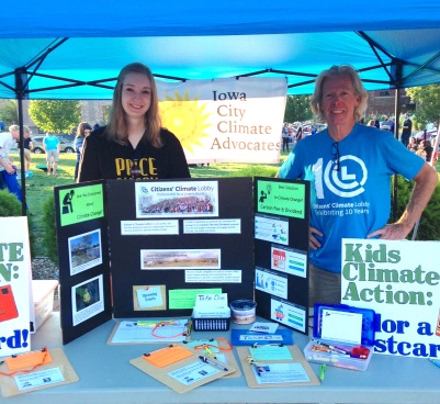 ICCA members Maria McCoy and Sean Turner encourage people to write to their representatives at a tabling event in Cedar Rapids, August 2017